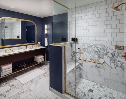 En suite bathroom with a deep soaking tub and enclosed glass shower.