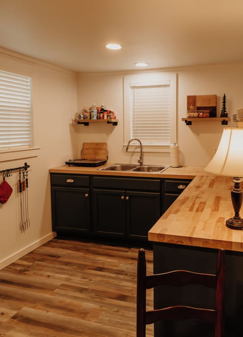 A view of the kitchen, equipped with a mini fridge and electric 2-burner stove