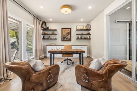 The office features a desk, chairs, and a Bluetooth keyboard, mouse and printer.