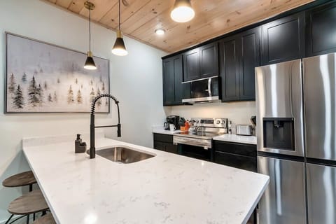 Modern design meets functionality with sleek countertops and stylish pendant lights!
