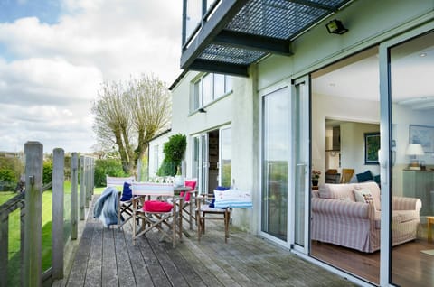 Decked area with picnic table and chairs at Dolawel