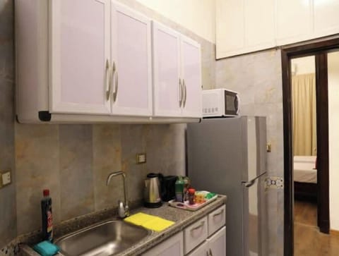 Fridge, microwave, electric kettle, cookware/dishes/utensils