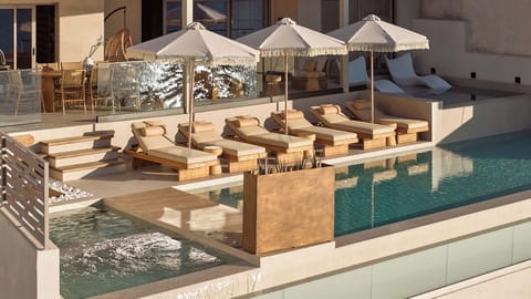 Experience the magic of the pool terrace as the sun sets over the horizon.