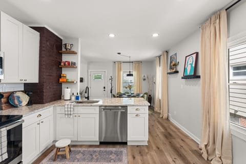 Walking into this kitchen feels like stepping into a Pinterest board - white cabinets and hardwood floors that make you want to cook up a storm in style! 🍳✨