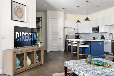 Open concept main living area with large designer kitchen and beautiful Arhaus furniture.