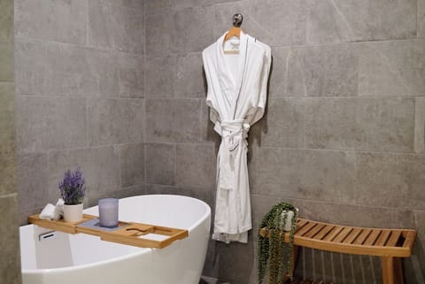 Walk-in Soaking Tub w/ waterfall tub filler.