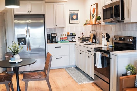 Full kitchen with Microwave, Induction stove, Fridge and Freezer and dining area