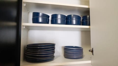 Everything you need for a perfect meal is included in our fully equipped kitchen, including dinnerware such as bowls, plates, mugs, glasses, wine glasses, and essential utensils.