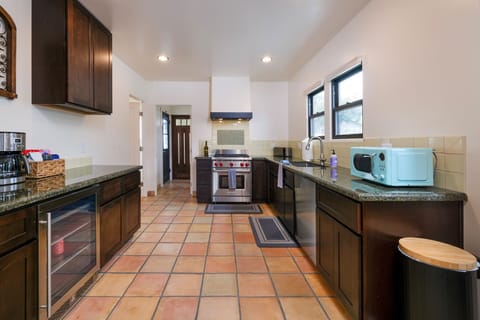 The gourmet kitchen is fully equipped with high end appliances