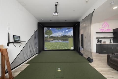 Basement Level: Family & Game Room w/ golf simulator, putting green, and pop-a-shot