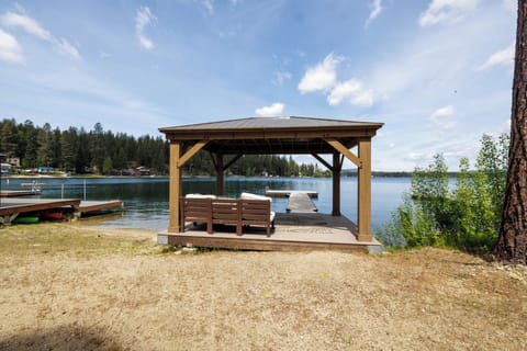 Beach area a seating under a gazebo and a private dock