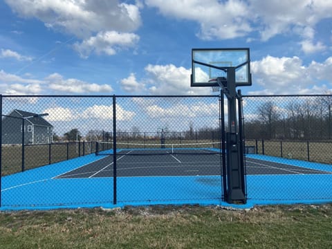 Full size tennis court and basketball goals with net and pickleball.
