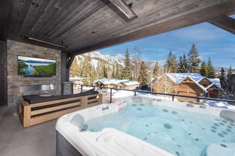 Relax and take in the mountain views from the private hot tub with heated patio, fireplace and television.