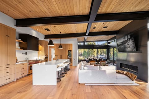 Main Living Space: Living room and kitchen, open layout, soaring windows, sliding glass doors to outdoor living space
