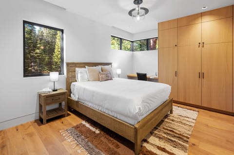 Bedroom 5: Queen bed, dresser, desk, en suite bath, lower floor