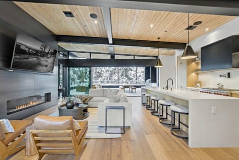 Main Living Space: Living room and kitchen, open layout, soaring windows, sliding glass doors to outdoor living space