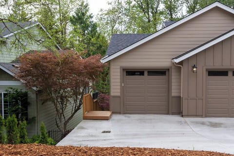 Stairs to downstairs condo to the left of the garage. No garage access. One parking space in front of left garage door.