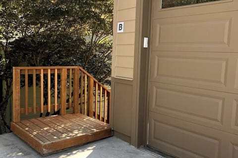 Private entrance down the stairs to the left of the garage.