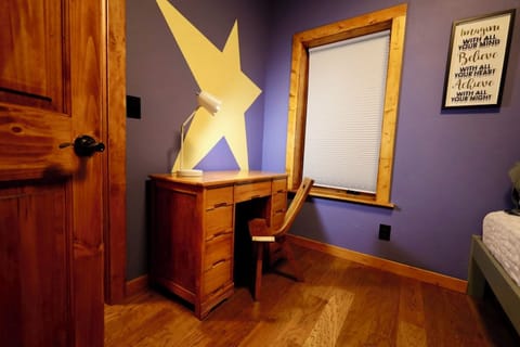 Bunk bed room with desk, chair and closet.