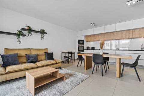 Unwind in the stylish living space, featuring a comfortable sofa, modern decor, and a flat-screen TV for your entertainment.