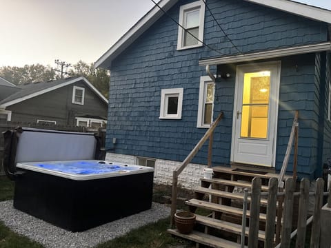 Private fenced yard with hot tub and cozy patio — your peaceful retreat minutes from shopping and dining.