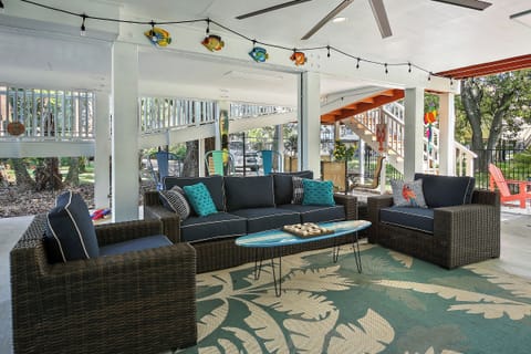 WOW!   Check out this great outdoor space, fully shaded with big screen TV, ceiling fan, and bar area!   So much fun to be had in and around this lovely property.  The owners really went all out.