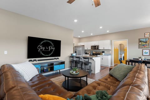 Upstairs living room holds a 75" TV with a Nintendo Switch.