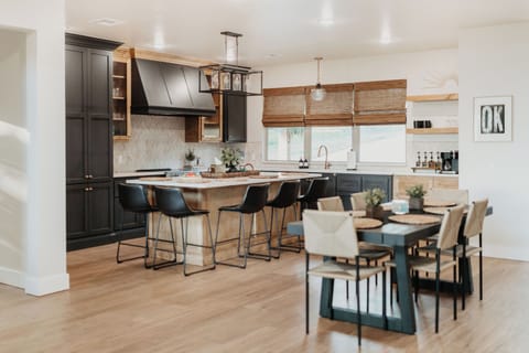 Fully stocked kitchen and island seating for 5. The dining table offers additional seating.