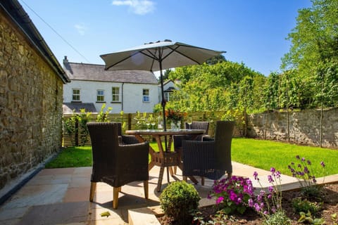 Secure garden with lawn and patio area with table and chairs