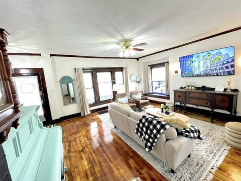 A vintage-inspired media console houses a flat-screen TV, offering a selection of classic films and contemporary shows for your entertainment.