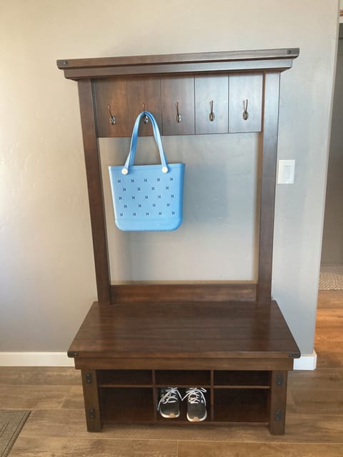 Bench by entry door for shoes, jackets, sweatshirts.