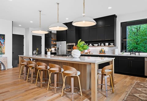 Gather around the island and enjoy the perfect blend of style and practicality in this kitchen. The modern appliances make cooking seamless.
