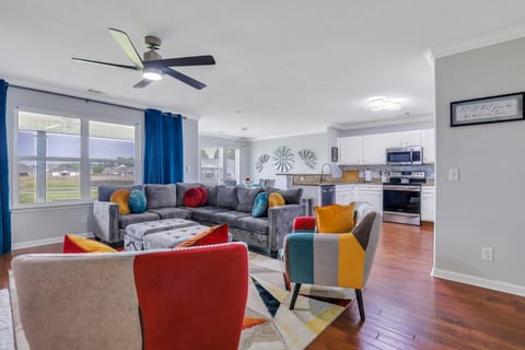 Artistically eclectic living room space! Full kitchen in background.