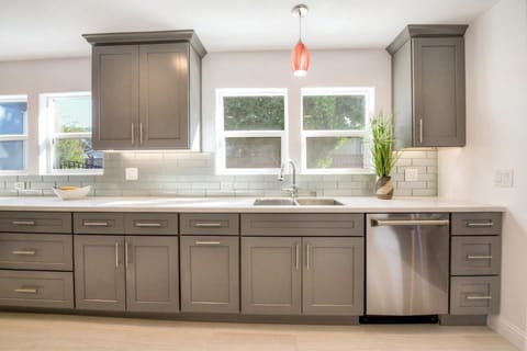 Extra large sized kitchen with cookware, pots, plates and cooking material