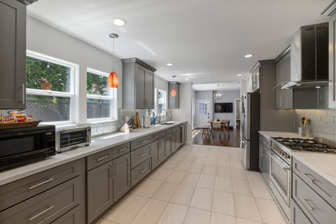 Extra large sized kitchen with cookware, pots, plates and cooking material