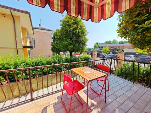 Cozy private terrace with colorful table and chairs, perfect for enjoying breakfast or aperitifs outdoors in the heart of Peschiera del Garda.