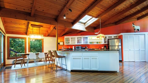 Dining area table seats 8 with 2 additional bar stools.