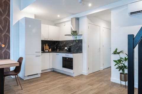 A modern kitchen area with sleek appliances and stylish cabinetry, offering a functional and clean design.