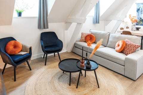 A stylish seating area with comfortable chairs and a sofa, offering a cozy space to relax and enjoy the surroundings.