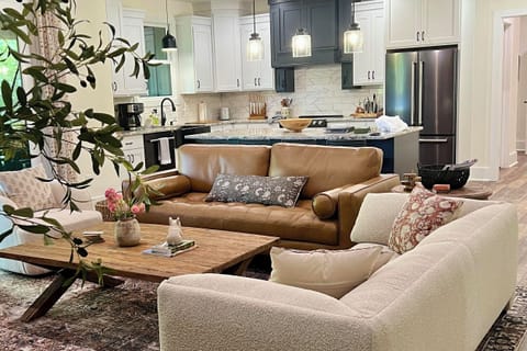 There's room for 12 in the living room with the sofas, chairs, and 4 bar stools.