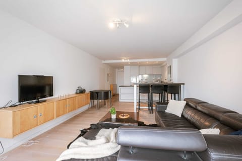 Spacious open-plan living and dining area with modern furnishings and natural light.