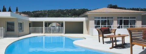 Relax and lounge by the shared outdoor pool.