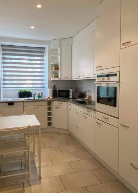 Bright and spacious kitchen with a big window and ample storage space -  fully equipped with dishwasher, fridge, microwave, oven, toaster, Nespresso coffee machine etc. 

A cozy table for casual dining or as additional tabletop space.