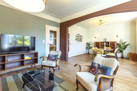 Spacious open-plan living and dining area, perfect for entertaining or relaxing. Enjoy the comfortable seating, modern decor, and ample natural light in this inviting space.