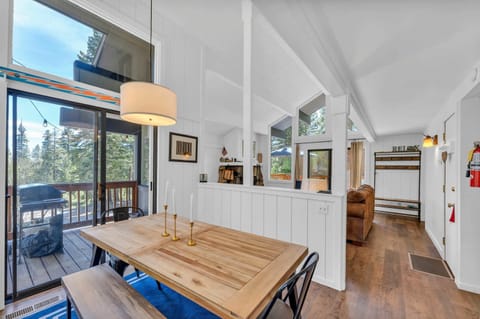Dining Room: 6-person dining table, soaring windows, access to deck, located between the living room and kitchen
