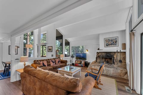 Living Room: 2 sofas, Smart TV, custom stone wood fireplace, board games, access to deck