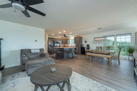 Open-concept living and dining room with Smart TV for streaming, cozy sectional, and gas fireplace
