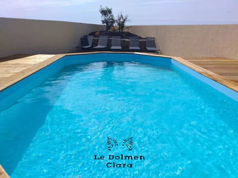 Pool area with deckchairs and loungers