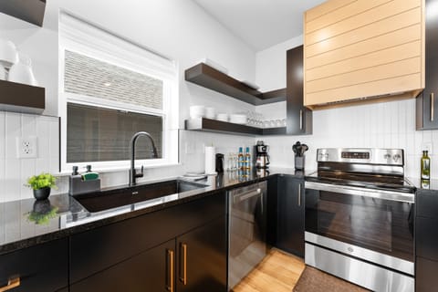 Modern kitchen fully equipped with premium appliances and essentials.