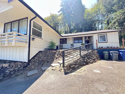 Exterior entrance with railing and pavers.